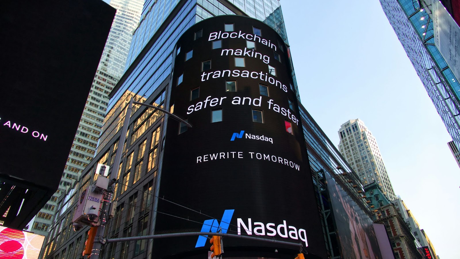 A digital billboard saying "Blockchain making transactions safer and faster."